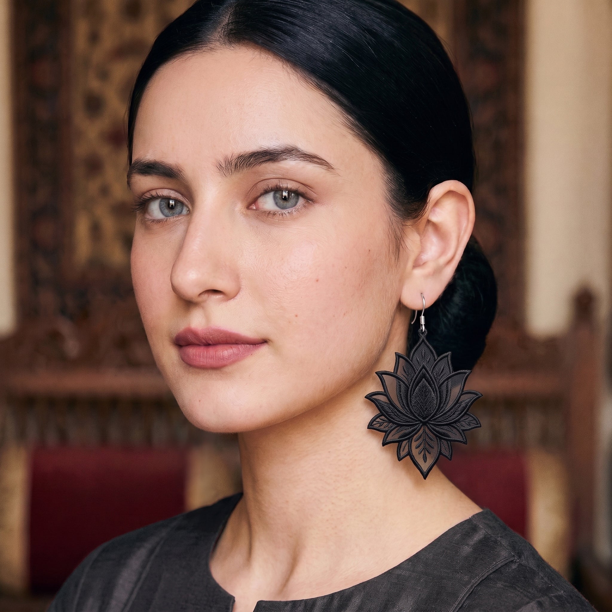 Black lotus drop earrings with layered petal detailing and silver hook